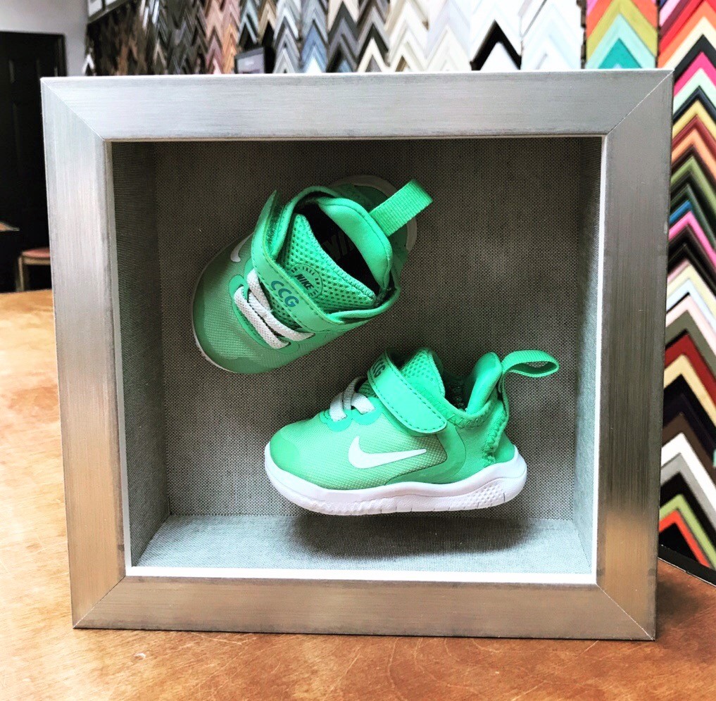 baby shoes in a shadowbox